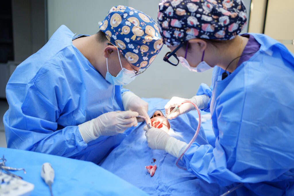 A doctor performing oral surgery