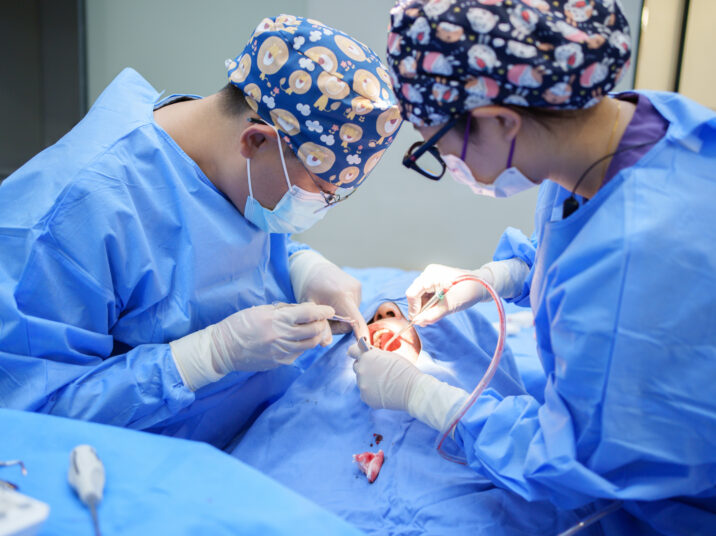 A doctor performing oral surgery