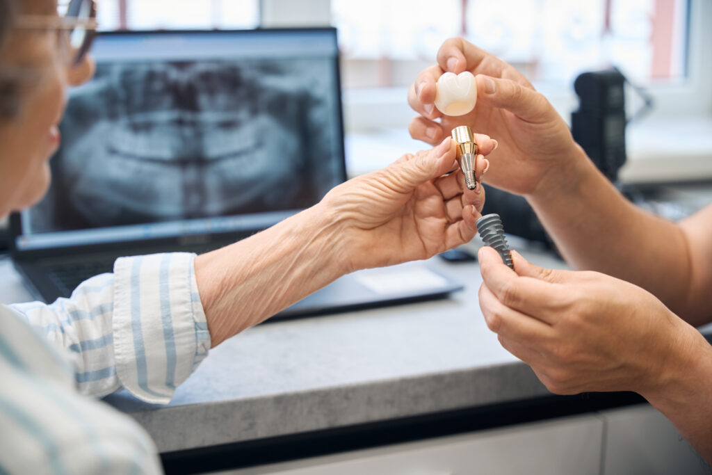 Prosthetist consults an elderly lady in a dental clinic