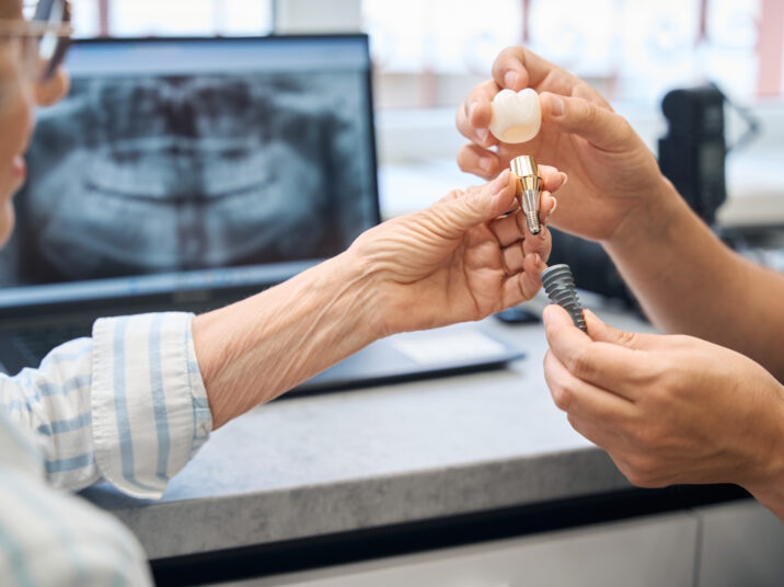 Prosthetist consults an elderly lady in a dental clinic