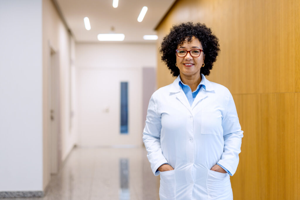 Mature female doctor smiling in hospital corridor