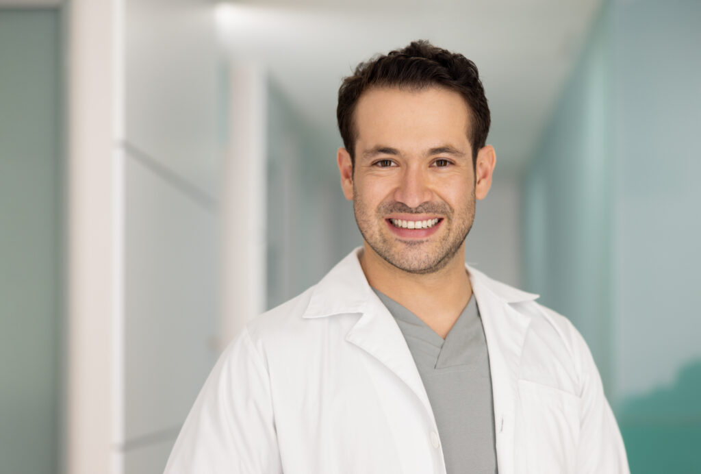 Portrait of a happy doctor smiling at the hospital