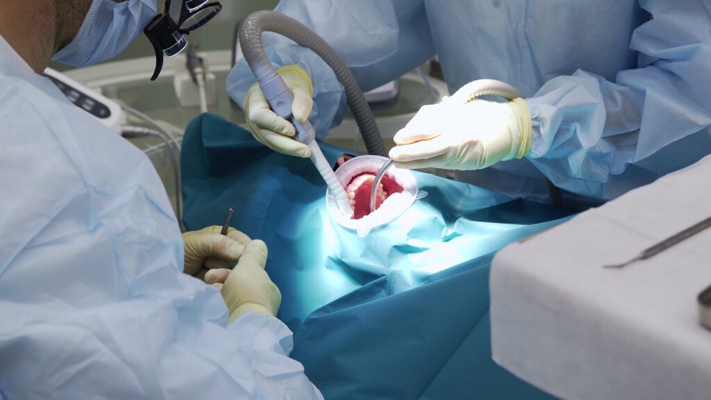 Professional,Doctors,Performing,Dental,Surgery,,Treating,Teeth,In,The,Patient's