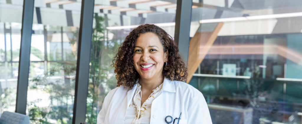 Female doctor smiles for hospital publicity photo
