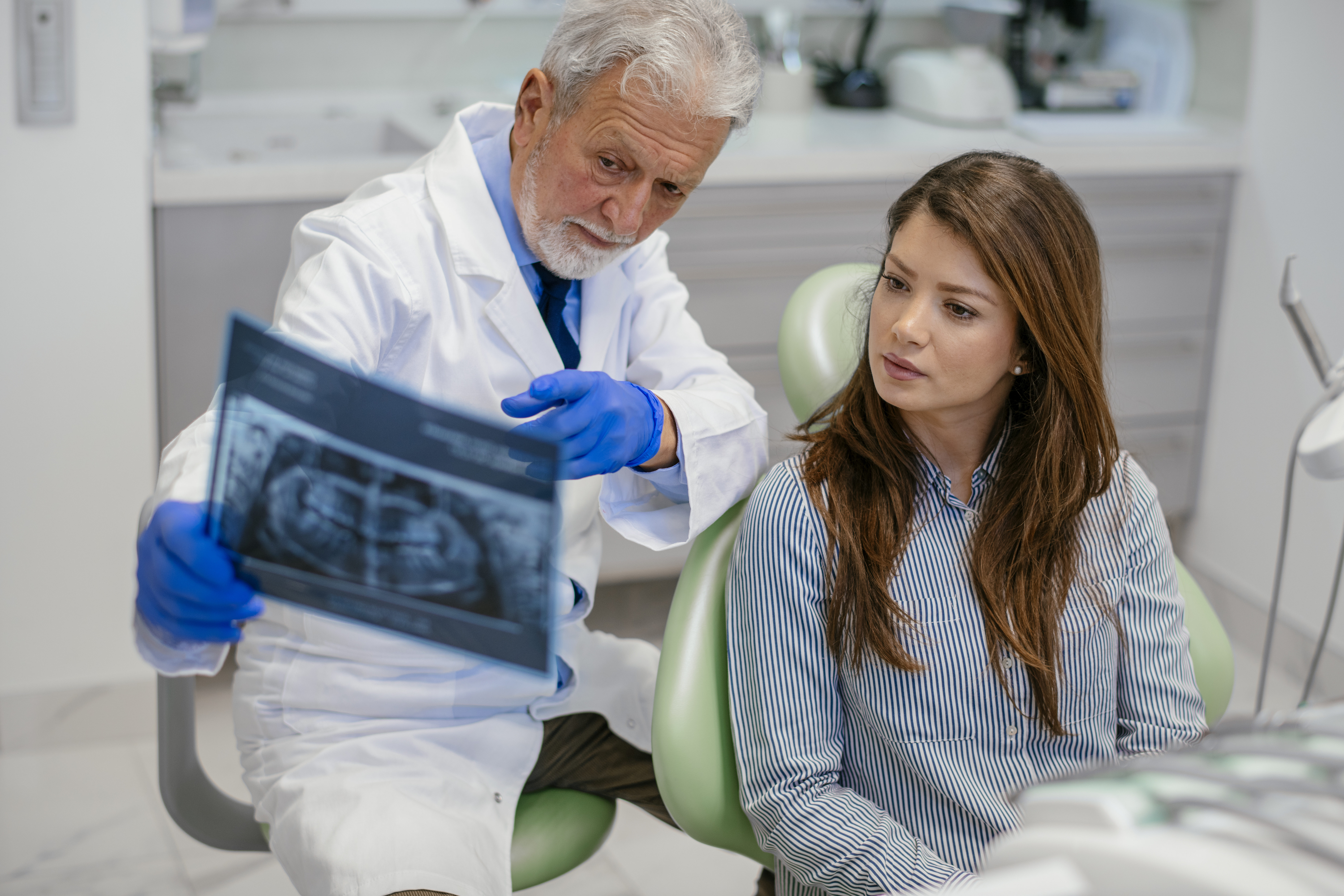 Dentist showing x-ray image to patient