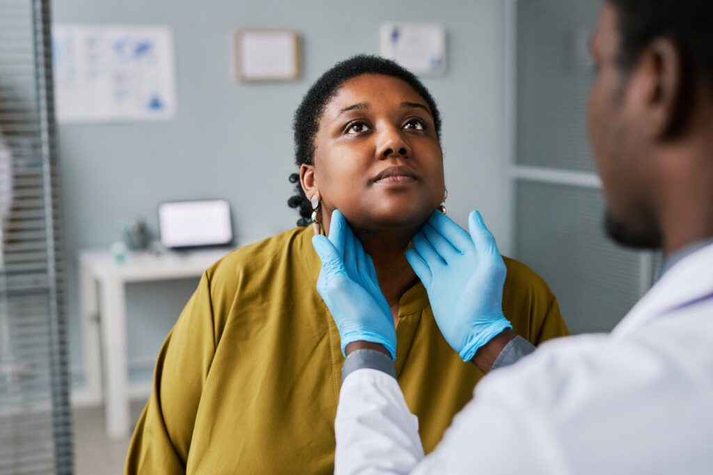 Portrait,Of,Black,Woman,At,Health,Checkup,With,Doctor,Palpating