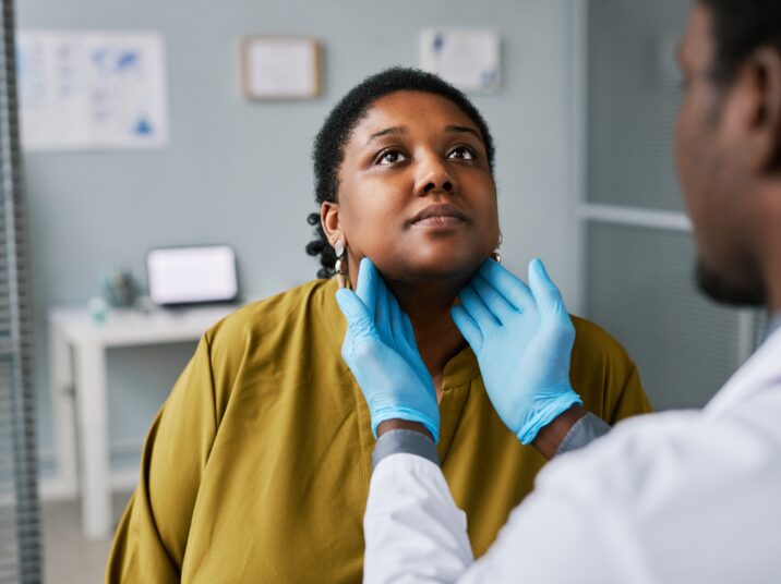 Portrait,Of,Black,Woman,At,Health,Checkup,With,Doctor,Palpating