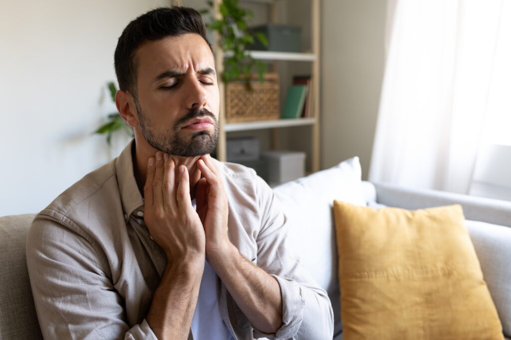 Man,Suffering,From,Sore,Throat,Touching,Neck,Feeling,Pain.,Copy