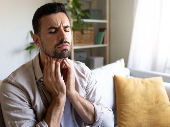 Man,Suffering,From,Sore,Throat,Touching,Neck,Feeling,Pain.,Copy