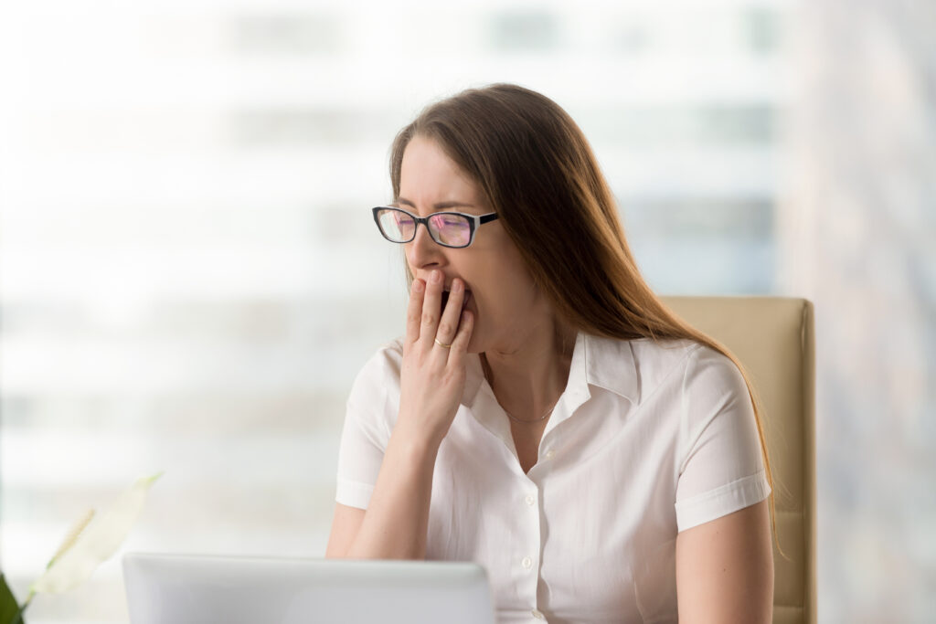 Businesswoman,Yawning,While,Sitting,In,Office.,Woman,Feeling,Lack,Of